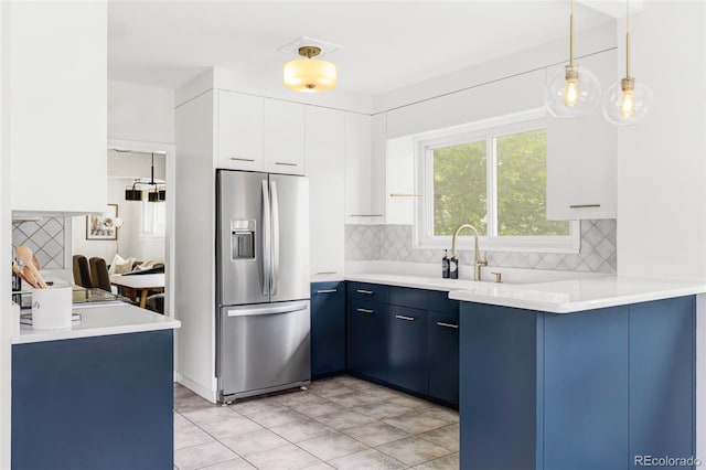 4421 Raleigh St, Denver, CO 80212 - kitchen featuring stainless steel refrigerator with ice dispenser, blue cabinets, tasteful backsplash, and light countertops