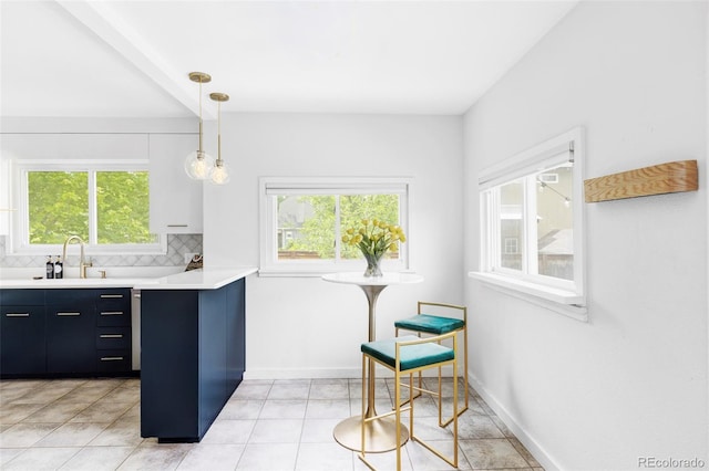 4421 Raleigh St, Denver, CO 80212 - kitchen featuring light countertops, tasteful backsplash, hanging light fixtures, and light tile patterned floors