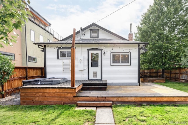 4421 Raleigh St, Denver, CO 80212 - rear view of property featuring a fenced backyard, a covered hot tub, a chimney, and a deck