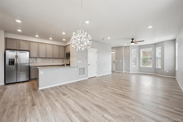 3831 E 141st Ave, Thornton, CO 80602 - kitchen featuring stainless steel appliances, a sink, a ceiling fan, a chandelier, and open floor plan
