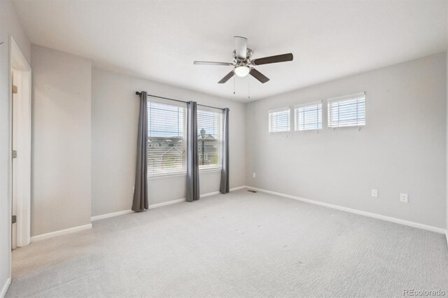 3831 E 141st Ave, Thornton, CO 80602 - carpeted spare room with baseboards and a ceiling fan