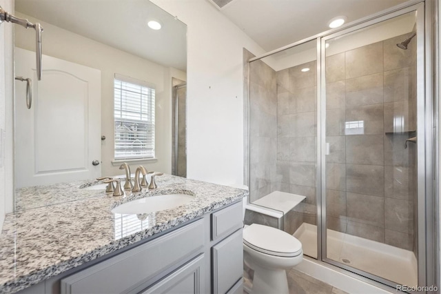 3831 E 141st Ave, Thornton, CO 80602 - bathroom featuring a shower stall, toilet, vanity, and recessed lighting