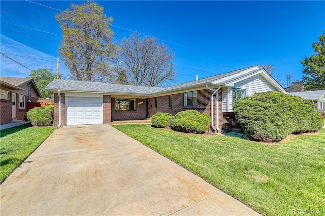 ranch-style house featuring a garage, brick siding, concrete driveway, and a front lawn