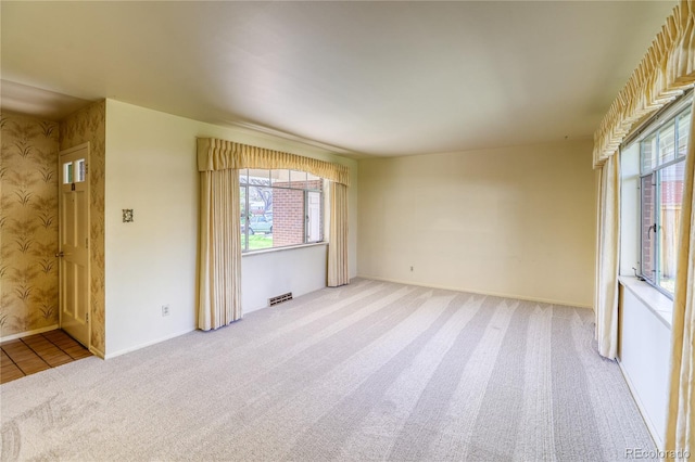 unfurnished room featuring carpet flooring and baseboards
