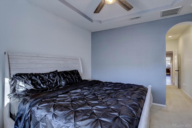 bedroom featuring a tray ceiling, ceiling fan, and carpet