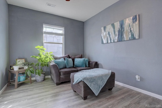 living area with light hardwood / wood-style flooring