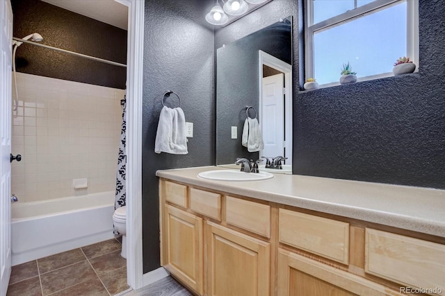 full bathroom with tile patterned floors, toilet, vanity, and shower / bath combo