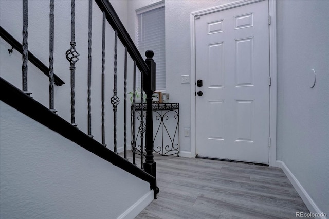 foyer entrance with light wood-type flooring