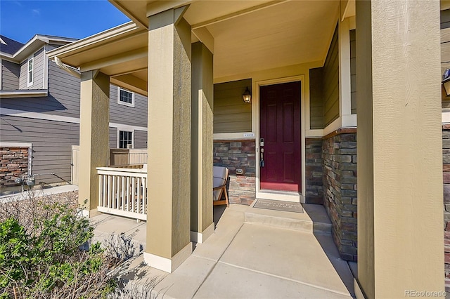 view of exterior entry with covered porch