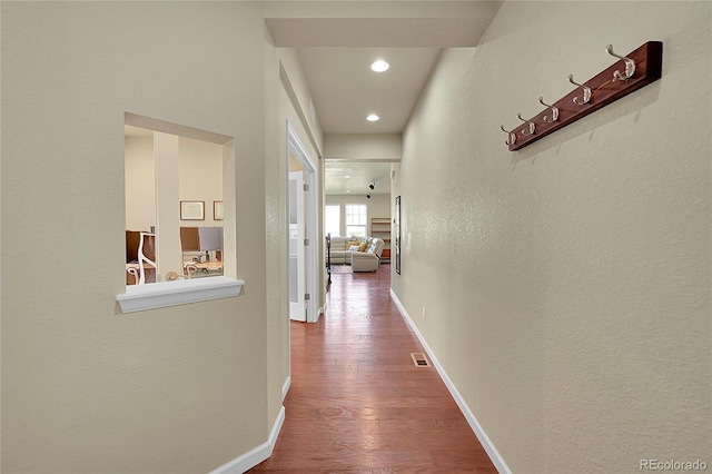 hallway with wood-type flooring