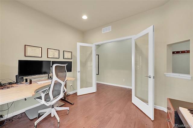 home office featuring wood-type flooring and french doors