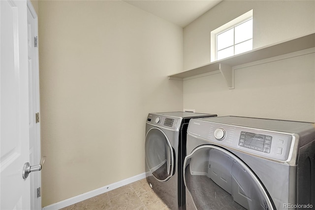 laundry room featuring separate washer and dryer and light tile patterned floors