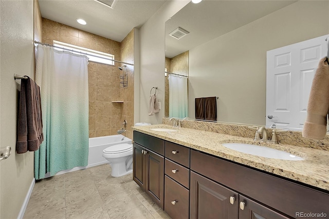 full bathroom with tile patterned flooring, a textured ceiling, toilet, dual vanity, and shower / tub combo