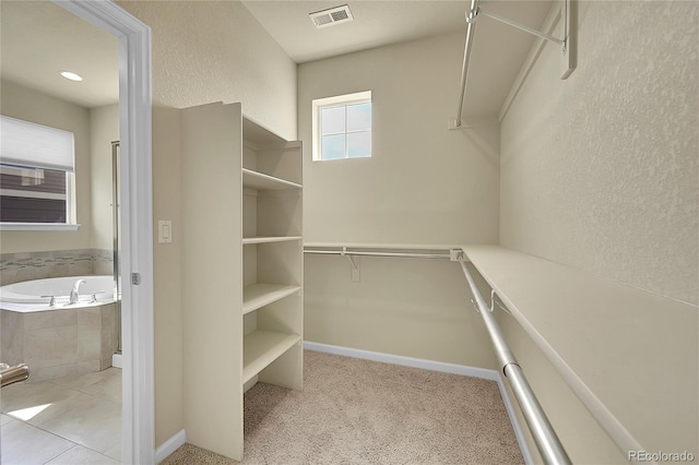 spacious closet featuring light tile patterned flooring