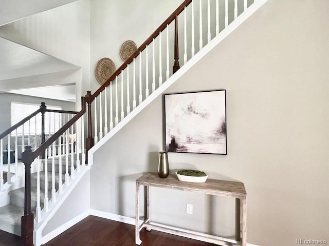 stairway featuring baseboards and wood finished floors