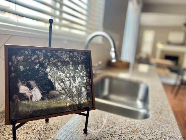 details with a sink and stone countertops