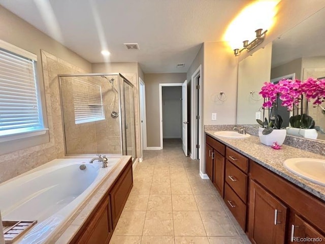 bathroom with tile patterned floors, visible vents, a sink, a shower stall, and double vanity