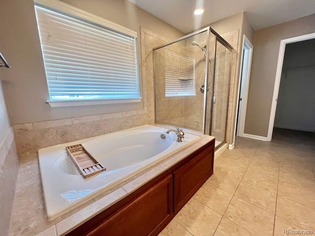 bathroom featuring a garden tub, a stall shower, and tile patterned flooring