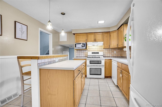 kitchen with visible vents, light countertops, under cabinet range hood, and white appliances