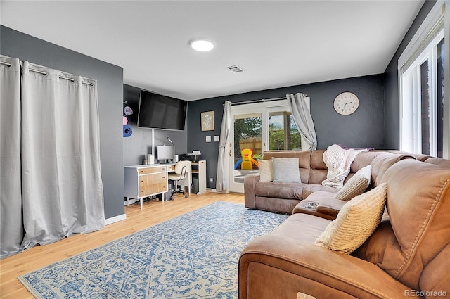 living area with visible vents and light wood finished floors
