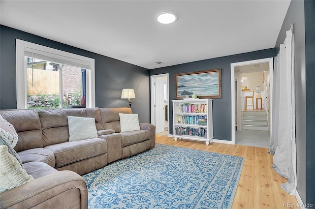 living room featuring light wood-style floors and visible vents