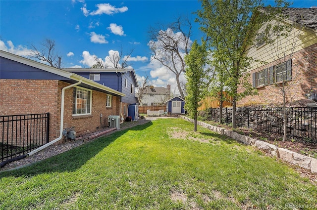 view of yard featuring central AC, fence, an outbuilding, and a storage unit