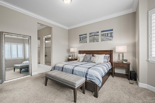 bedroom with light colored carpet, ornamental molding, baseboards, and ensuite bath