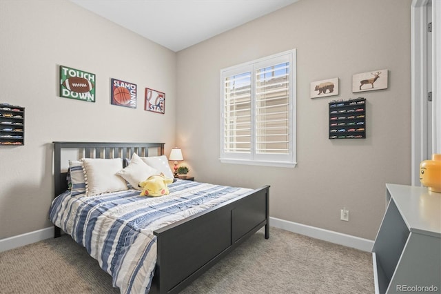 bedroom with baseboards and carpet