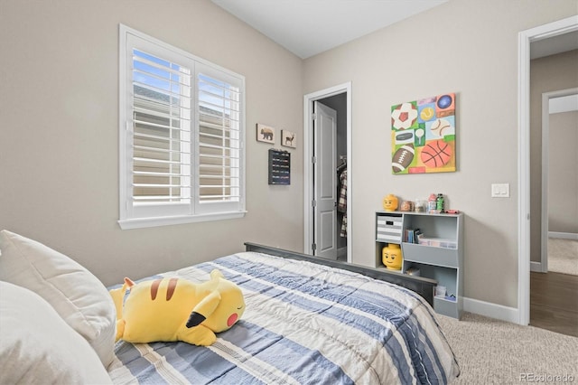 bedroom featuring carpet and baseboards