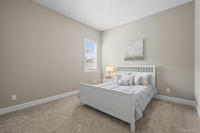 bedroom featuring baseboards and light colored carpet