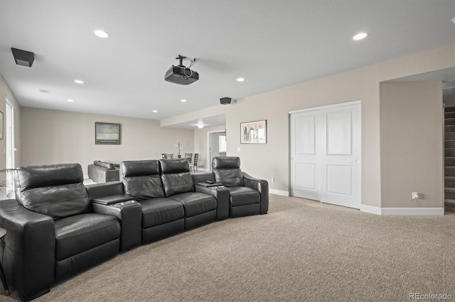 carpeted home theater room with recessed lighting and baseboards