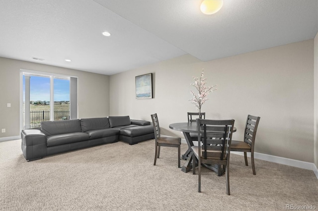 dining space with light colored carpet, baseboards, and recessed lighting