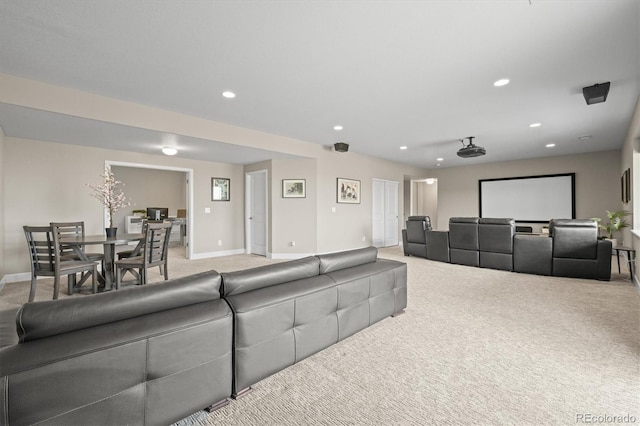 home theater featuring light colored carpet, recessed lighting, and baseboards