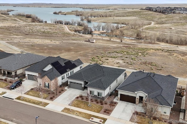aerial perspective of suburban area featuring a nearby body of water