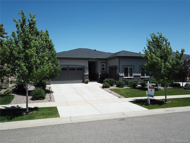 26741 E Peakview Pl, Aurora, CO 80016 - view of front of property featuring an attached garage, stucco siding, driveway, and stone siding