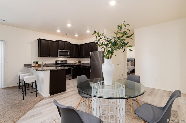 dining space with visible vents, baseboards, light wood-style flooring, and recessed lighting