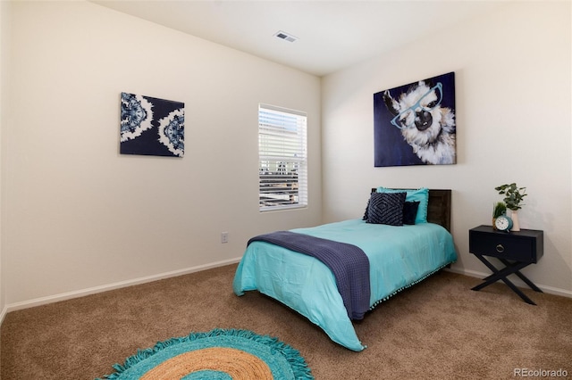 carpeted bedroom with visible vents and baseboards