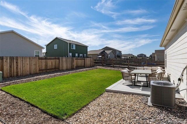 view of yard with a fenced backyard, a residential view, cooling unit, and a patio