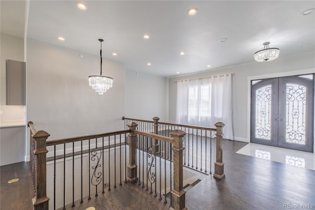 entrance foyer with a chandelier, wood finished floors, french doors, and recessed lighting