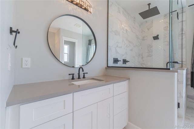 full bath with a marble finish shower and vanity