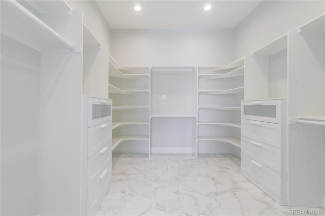 spacious closet with light marble finish flooring