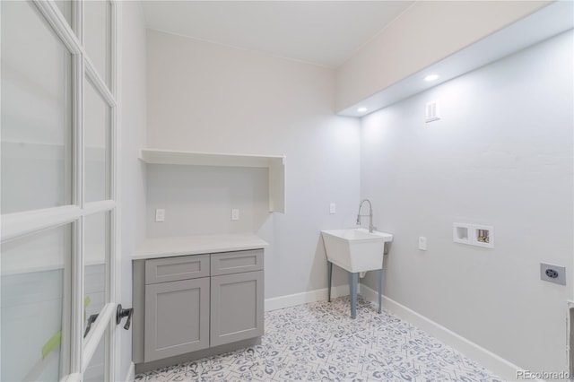 laundry room featuring hookup for an electric dryer, washer hookup, and baseboards
