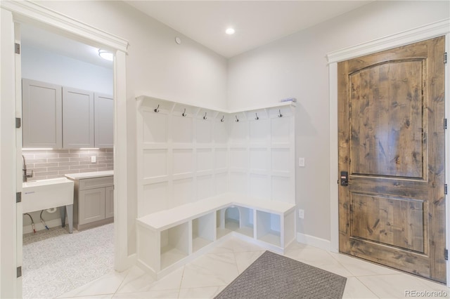 mudroom with baseboards and recessed lighting
