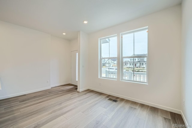 700 N Bently St, Watkins, CO 80137 - empty room with baseboards, light wood-type flooring, and recessed lighting