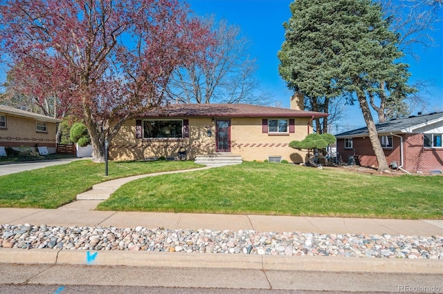 view of front of home with a front yard, brick siding, and a chimney