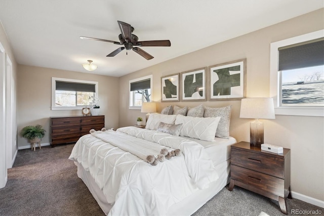 carpeted bedroom featuring baseboards and ceiling fan