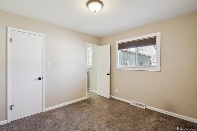 unfurnished bedroom with visible vents, baseboards, and carpet floors