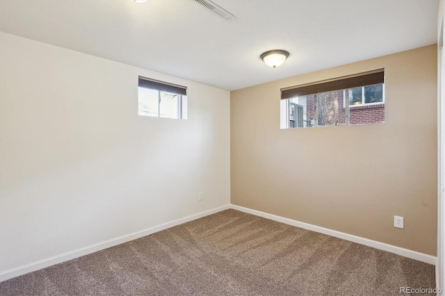 basement with carpet flooring, visible vents, and baseboards