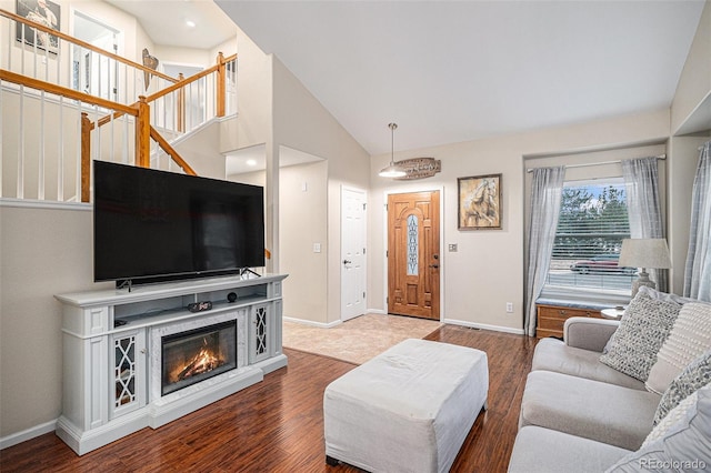 living room with hardwood / wood-style flooring and high vaulted ceiling