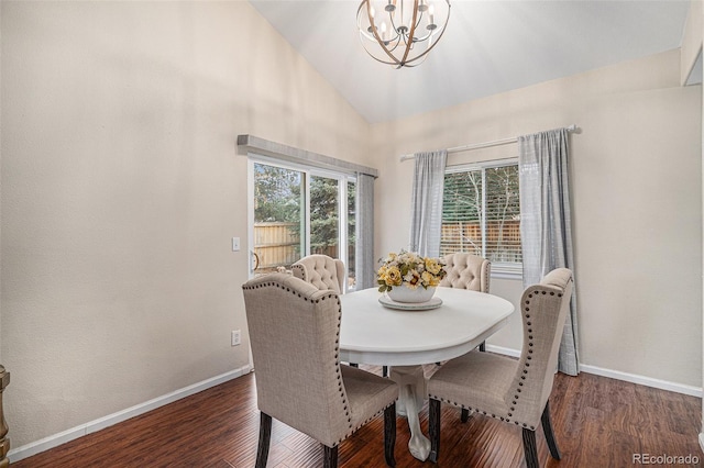 dining room with an inviting chandelier, high vaulted ceiling, and dark hardwood / wood-style floors